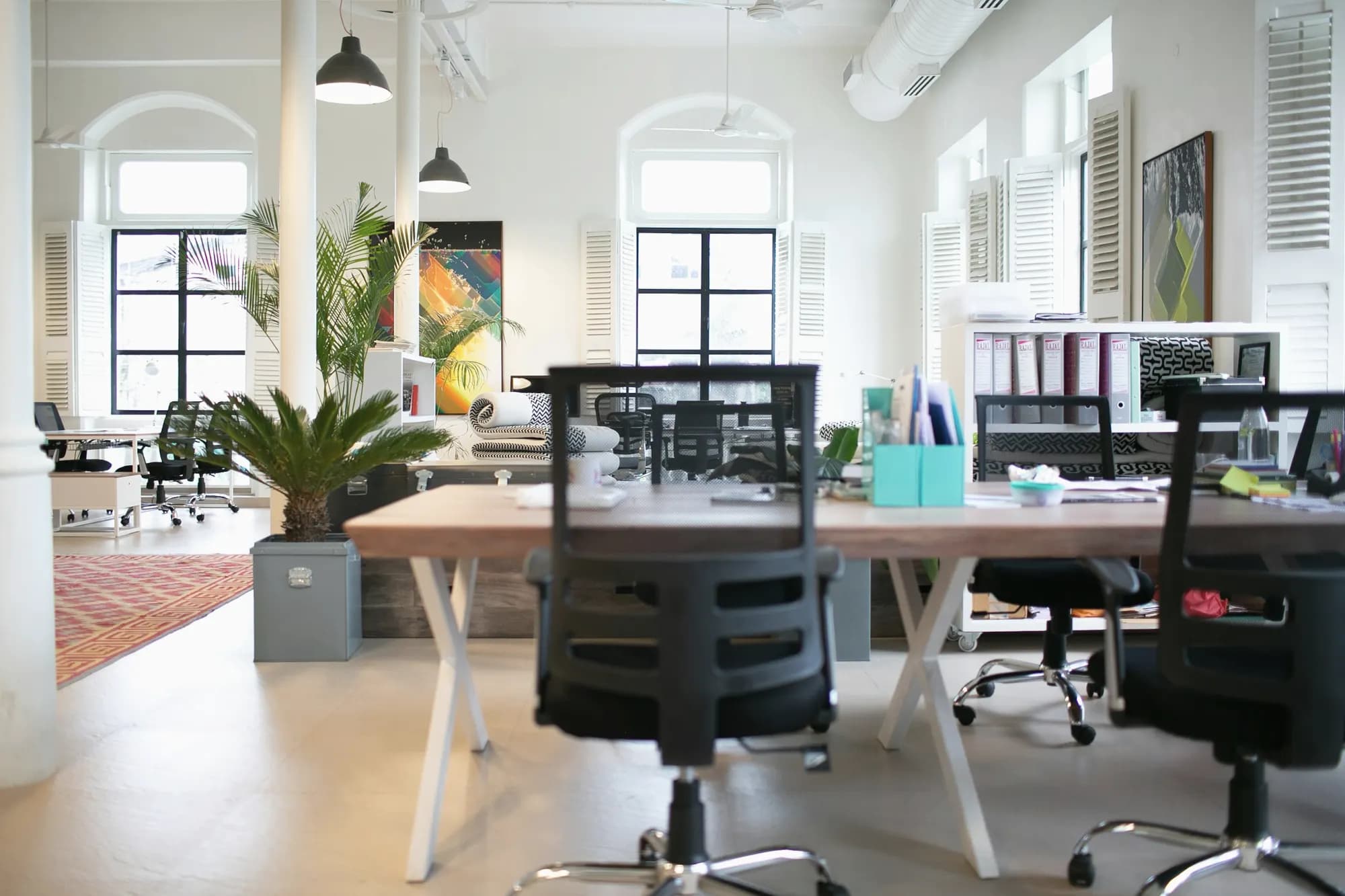 A bright, empty office in Mumbai with a long table and chairs